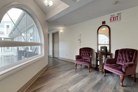 Hallway seating beside large windows.