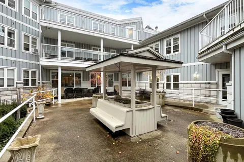 Courtyard with garden beds, benches and paved paths.