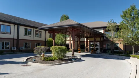 Building with a covered entrance and a circular driveway