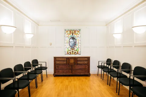 Chapel with stained glass window and rows of chairs