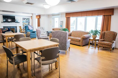 Seating and activity tables beside tall windows