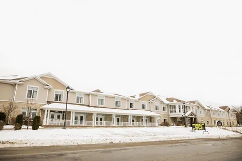 Residence facade with balconies and snow along the street