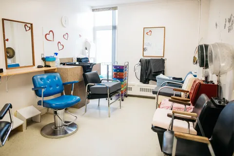 Hair salon with styling chairs and hood dryers