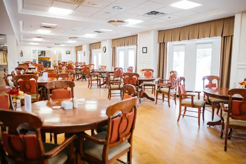 Dining room with round wooden tables beside large windows