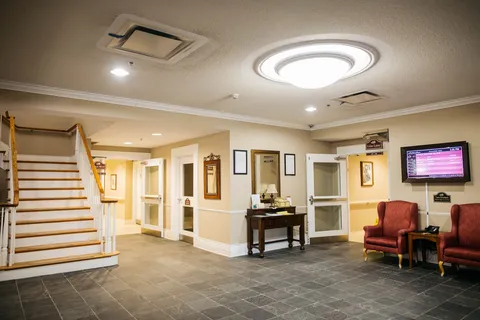 Entrance lobby with staircase, seating and reception counter