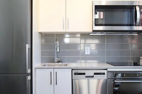 Kitchen with white cabinets, appliances and a sink.