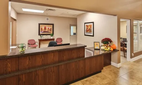 Reception desk with flower arrangements and framed artwork