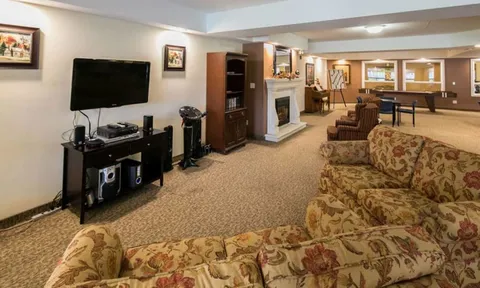 Lounge with sofas, fireplace and television