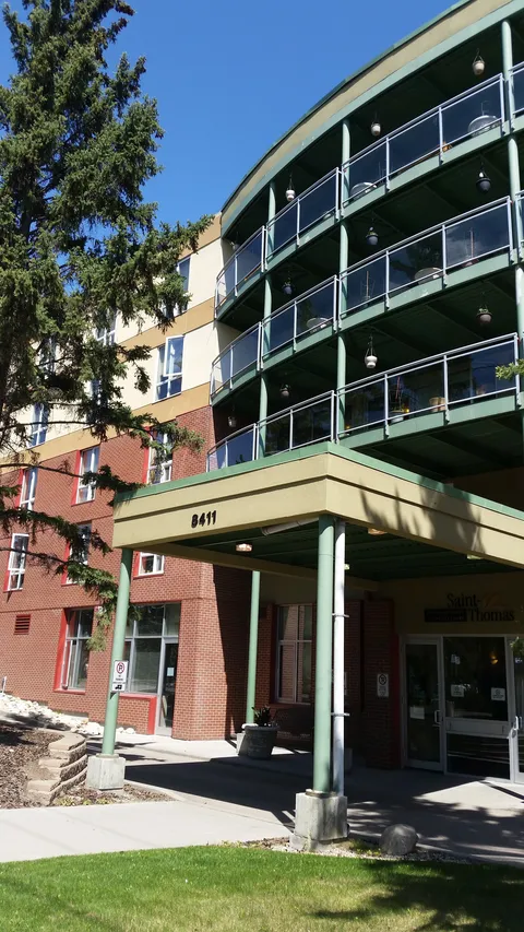 Residence exterior with glass-fronted sections and a projecting entrance