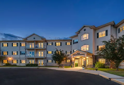 Building and landscaped entrance at dusk