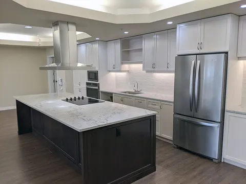 Kitchen with an island, white cabinets and stainless steel appliances