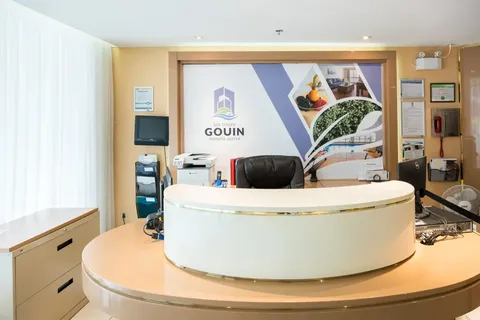 Reception desk with chairs and a window.