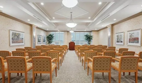 Room with rows of chairs facing a lectern