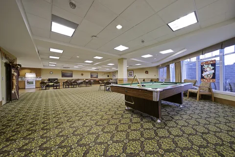 Games room with pool tables beside windows.