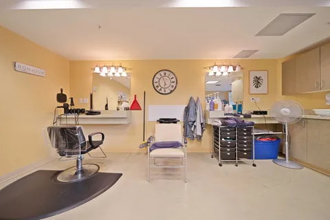 Hair salon with styling chairs, mirrors and washbasins.
