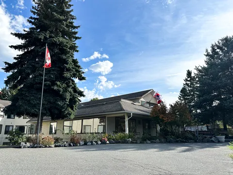 Residence exterior with entrance canopy and landscaped frontage.