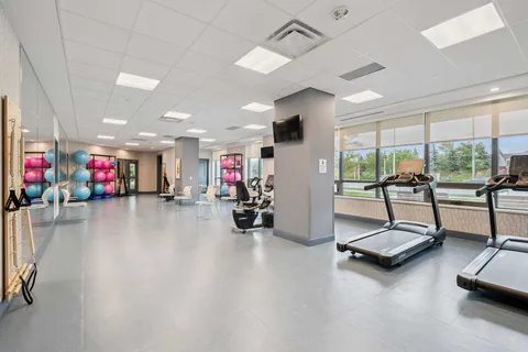 Exercise room with treadmills, fitness equipment and mirrors
