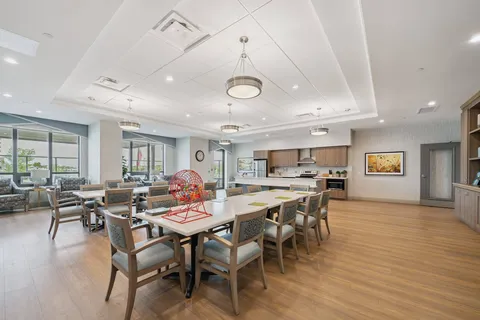 Room with tables, chairs and a kitchen counter