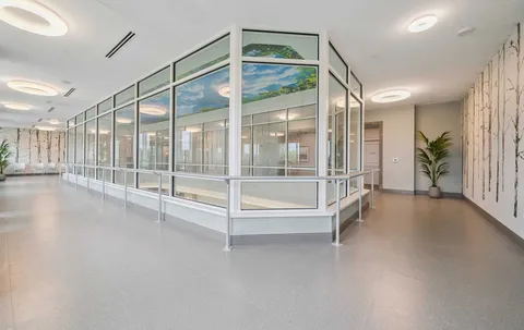 Glazed corridor with handrails and large windows