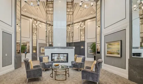 Room with upholstered chairs around a fireplace
