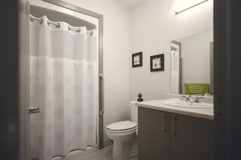 Suite bathroom with a bathtub, toilet and sink.
