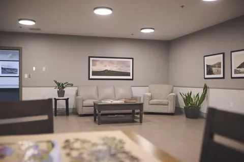 Lounge with sofas, armchairs and framed wall pictures.