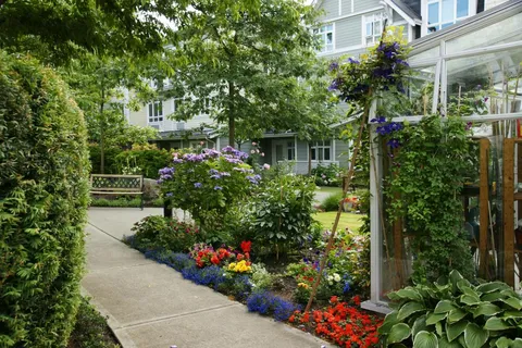 Garden path beside the residence with shrubs and flowers