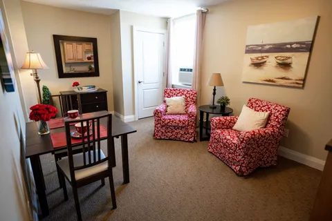 Sitting area with two patterned armchairs and a dining table
