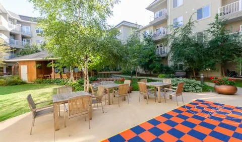 Courtyard with patio tables, a gazebo and large outdoor checkerboard