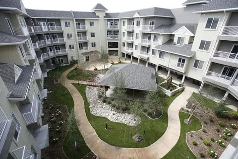 Multi-storey residence surrounding a landscaped courtyard and gazebo