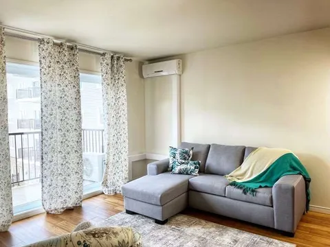 Suite sitting area with a sofa beside a patio door.