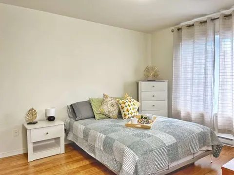 Bedroom with a bed, chest of drawers and bedside furniture.