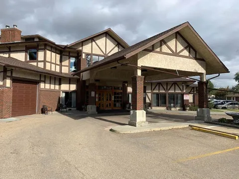 Building frontage with a covered entrance and paved driveway.