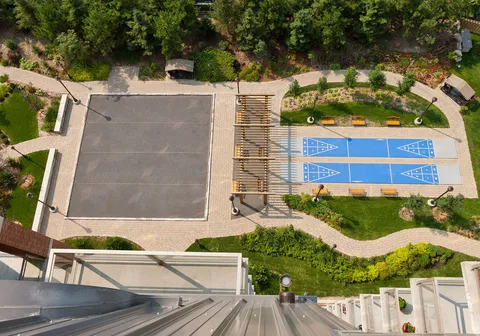 Overhead view of shuffleboard courts, benches and planted paths