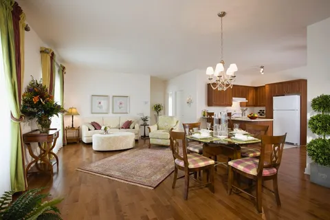 Open sitting and dining area beside a kitchen