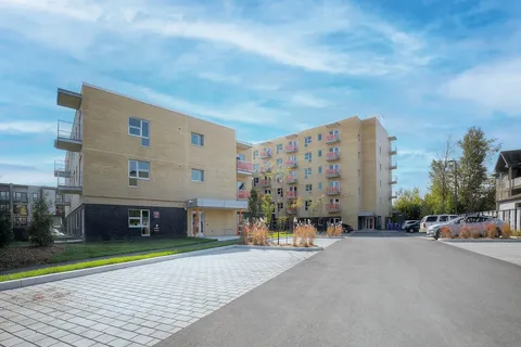 Residence exterior beside a paved parking area.