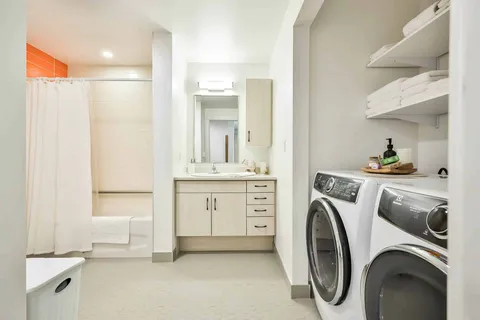 Apartment laundry area adjoining the bathroom.