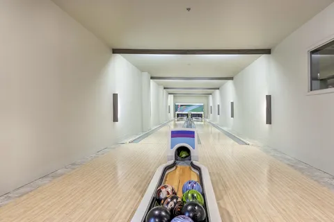 Bowling lanes with balls, a ball return and pins
