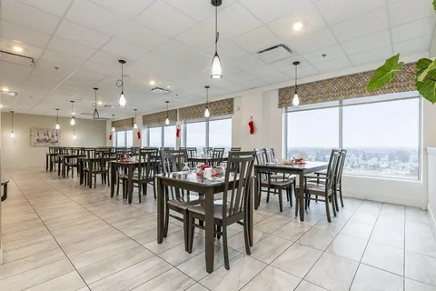 Dining room with set tables, pendant lights and large windows