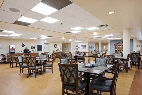 Dining room with wooden tables and chairs.