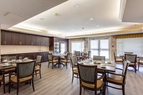 Dining area with small tables beside a long counter