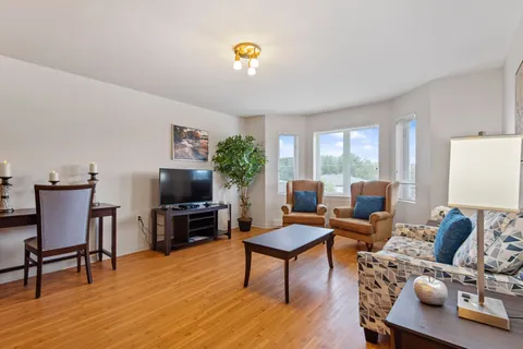 Sitting area with a sofa, armchairs, a television and a coffee table