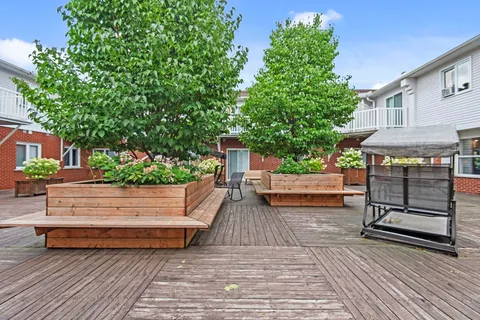 Wooden terrace with benches, planter boxes and a white railing
