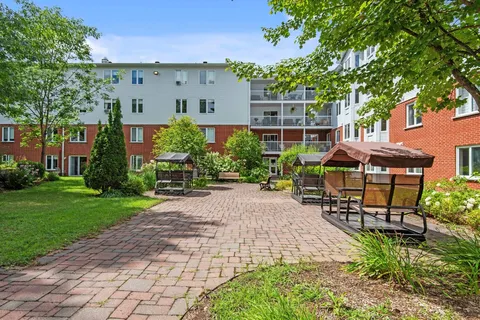 Courtyard with lawns, trees, paths and outdoor seating