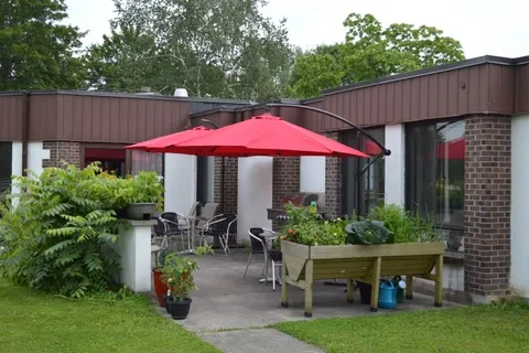 Courtyard with potted plants and a red patio umbrella