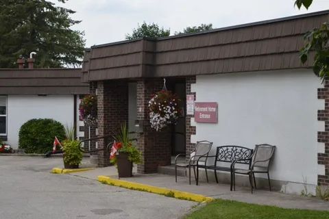Residence entrance with flower baskets and outdoor benches