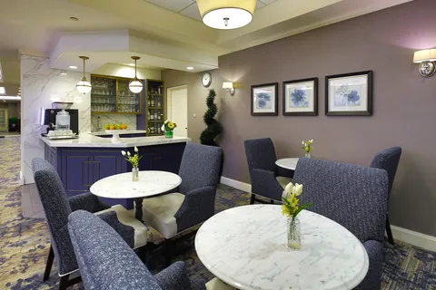 Bistro seating with round tables and upholstered chairs.