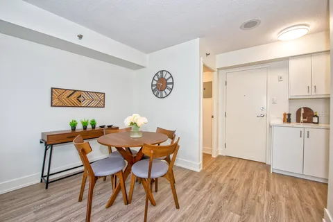 Suite dining area with a round table beside a kitchenette.