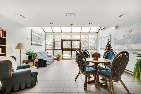 Sunroom seating and table beside tall windows