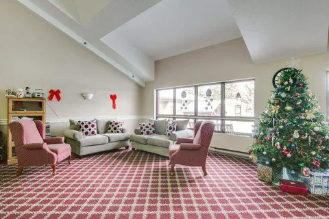 Lounge seating beside wide windows and a decorated tree